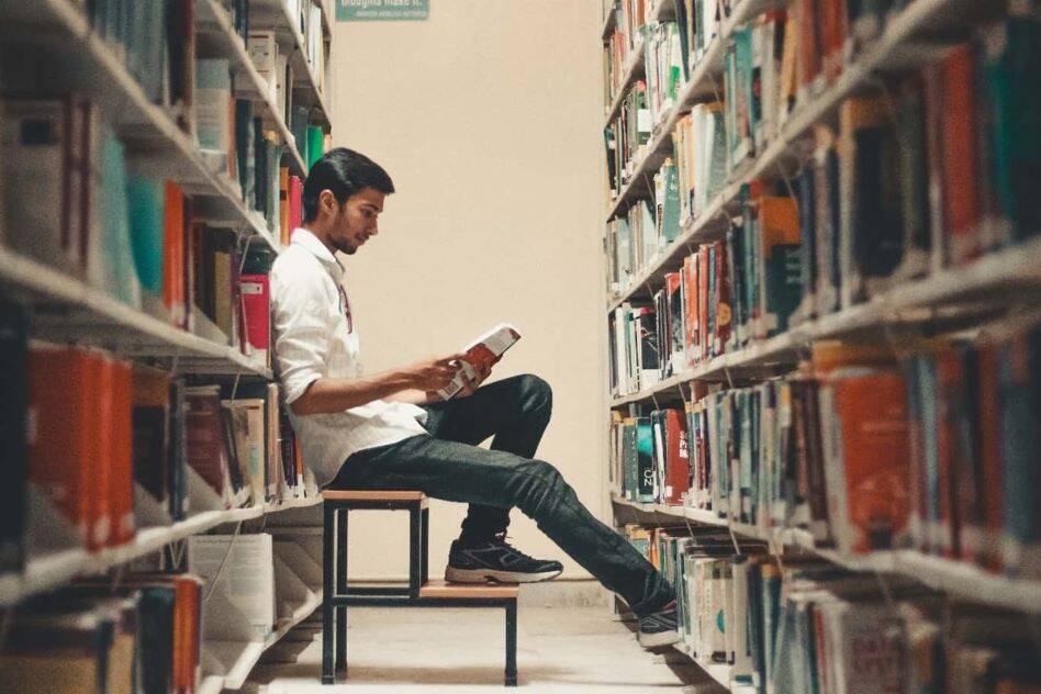 student in college library