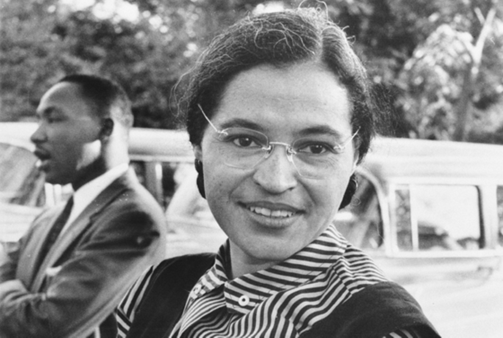 Rosa Parks smiled at the Montgomery Bus Boycott, and Martin Luther King stood in the distance behind her.